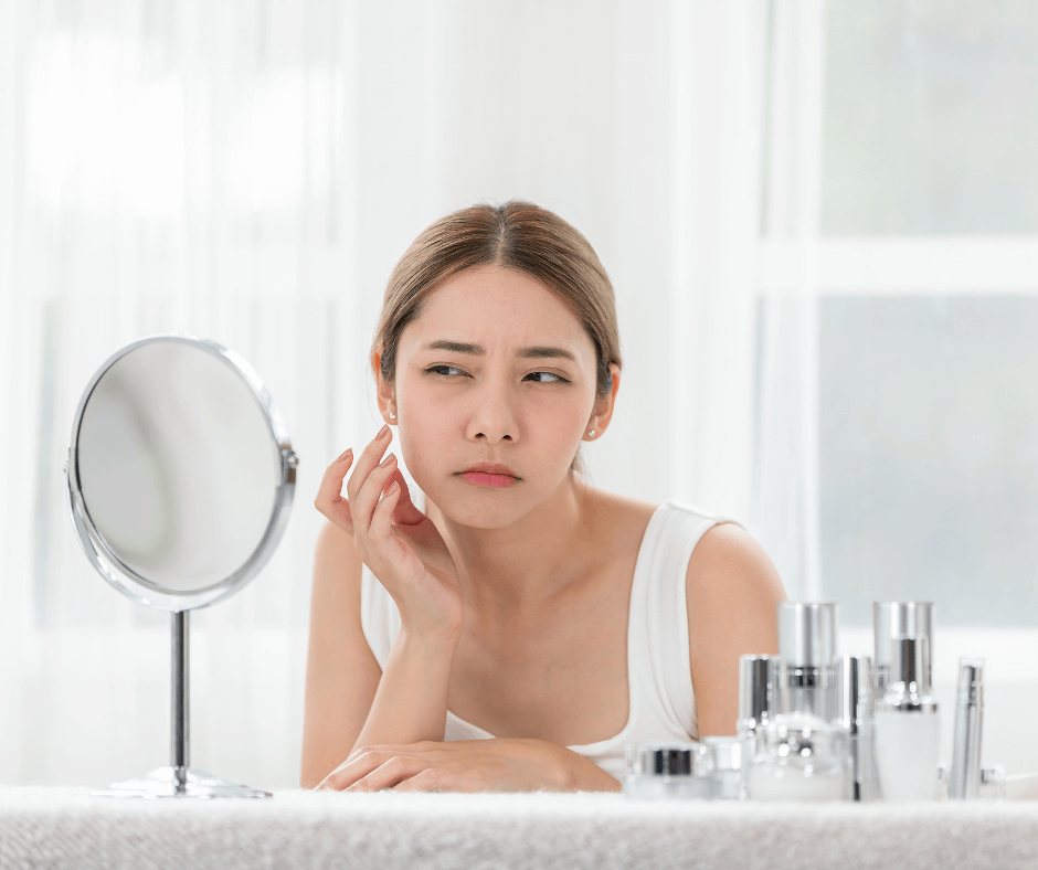 image of a lady looking at skin in a mirror