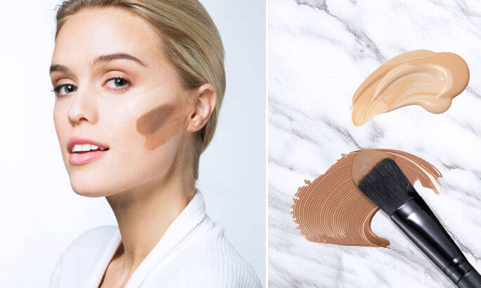 woman with streak of face makeup and makeup brush with face makeup
