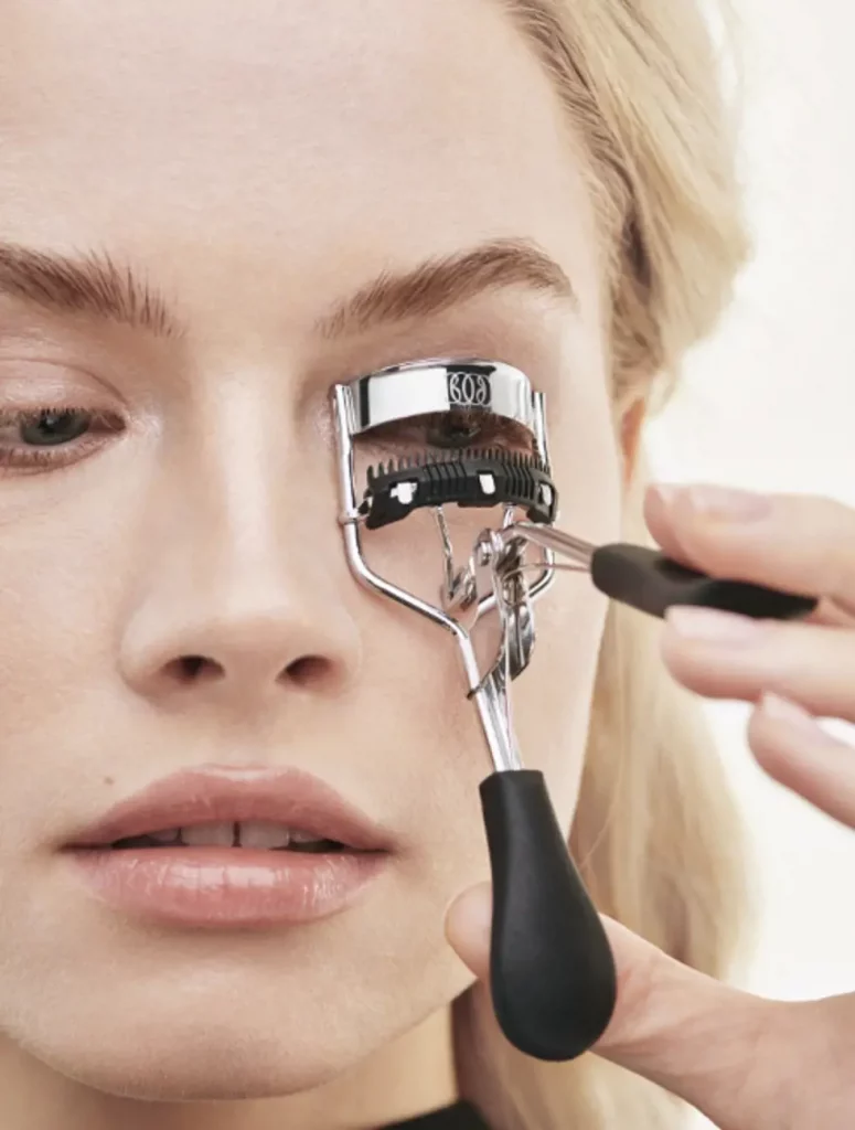 lady using eyelash curler
